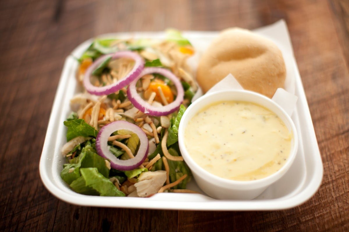 Ceasar salad with a brocolli cheese on a wooden table