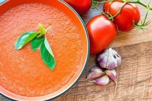 tomato-basil-soup Tomato Basil Soup with raw tomatoes and onion bulb beside it