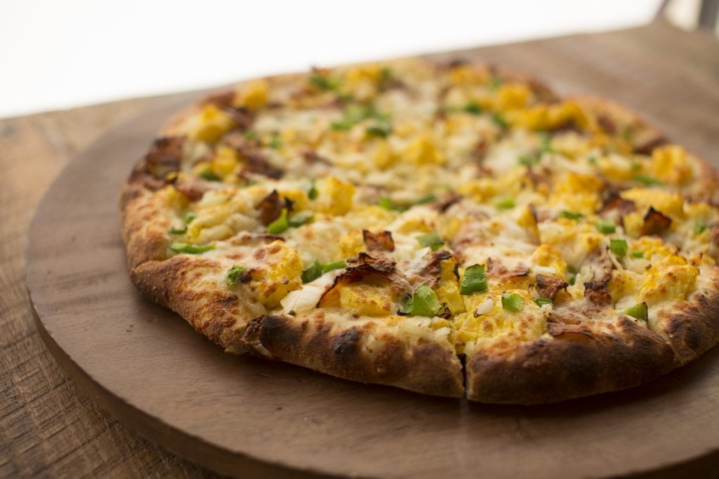 Breakfast Pizza Pizza on a wooden table